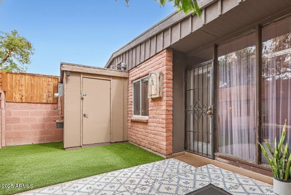 Front view of a house entrance with a metal security door and a small window.