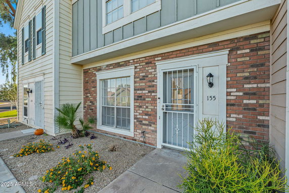 Front view of a two-story house with brick and siding exterior.