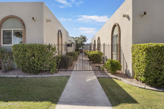 Front view of a building with large windows and a gated entrance.