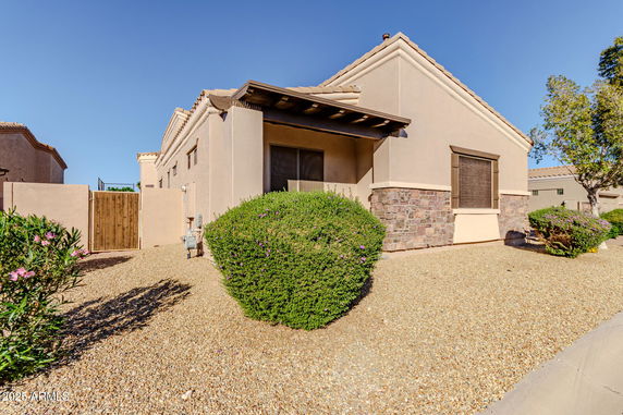 Front view of a single-story house with stone accents and stucco exterior.