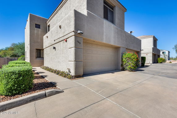 Front view of a two-story house with a garage.