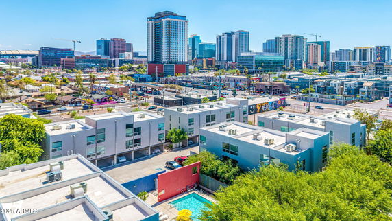 Panoramic view of a residential area with modern buildings and a swimming pool.