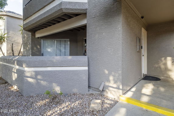 Front view of a building with a textured exterior and a small entrance area.