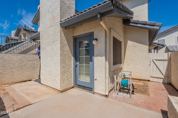 Back view of a house with a small patio area.