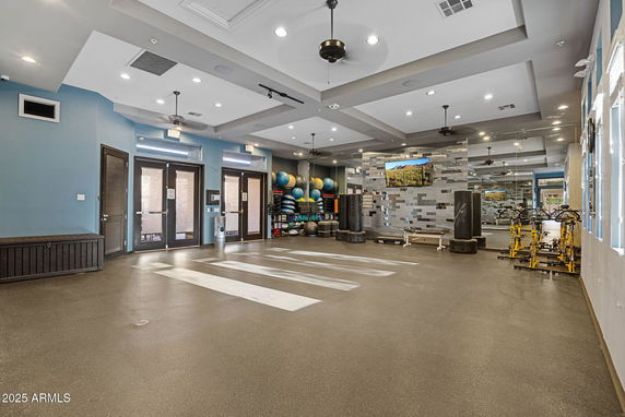 Indoor gym area with exercise equipment and wall mirrors.