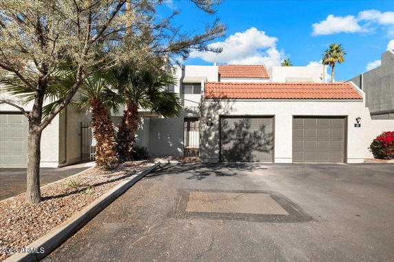 Front view of a house with a double garage and tiled roof.