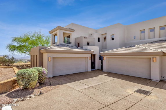 Front view of a modern two-story house with a three-car garage.