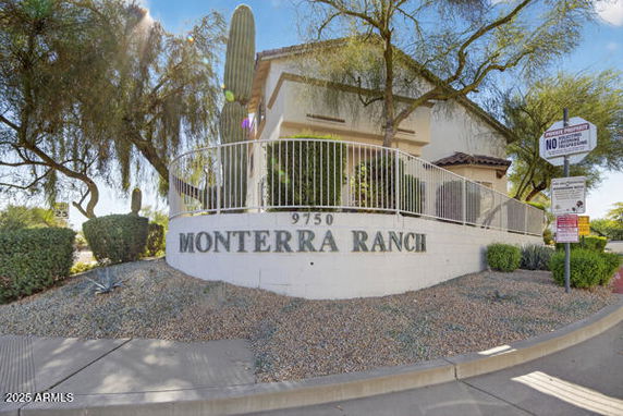 Front view of Monterra Ranch building entrance with fence and signage.