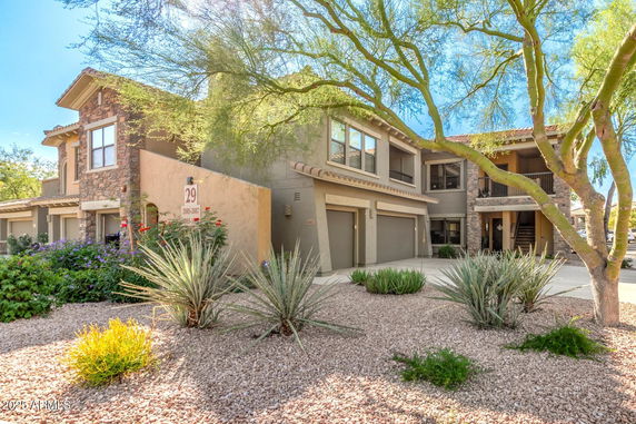 Front view of a two-story building with stone and stucco exterior.