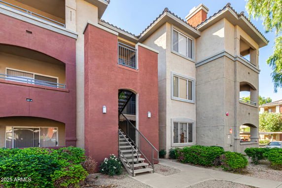 Front view of a multi-story residential building with balconies.