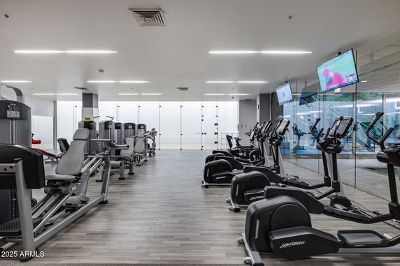 Interior view of a gym with various exercise machines and equipment.