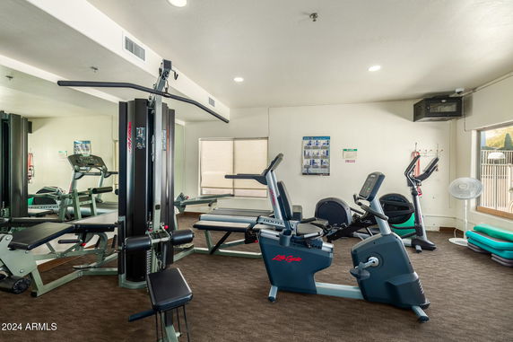 Indoor gym area with various exercise equipment.