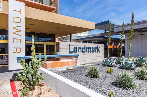 Front view of a building entrance with a sign labeled 'Tower Landmark'.