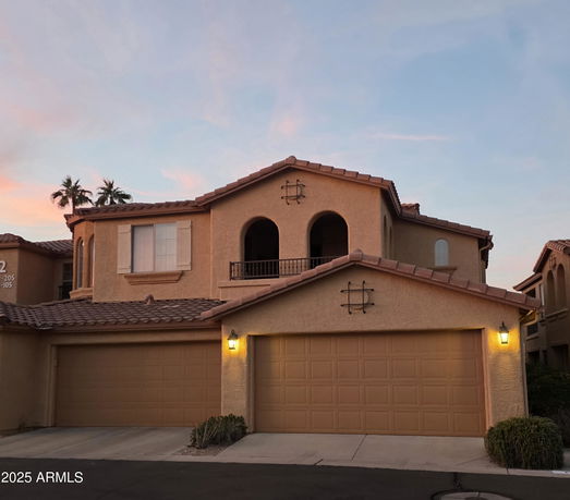 Front view of a two-story house with a three-car garage
