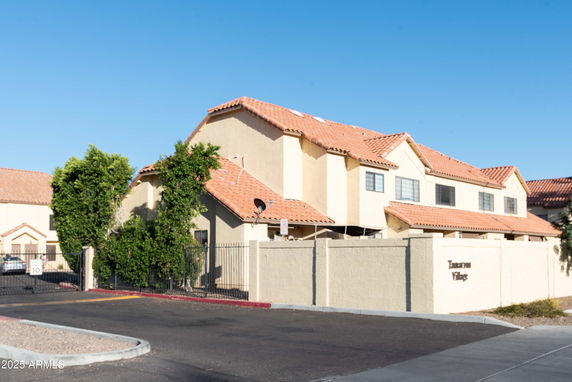Front view of a multi-story building with a tiled roof.