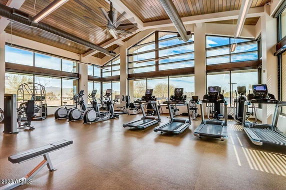 Gym area with exercise equipment and large windows.