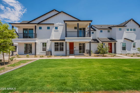 Front view of a two-story house with balconies.