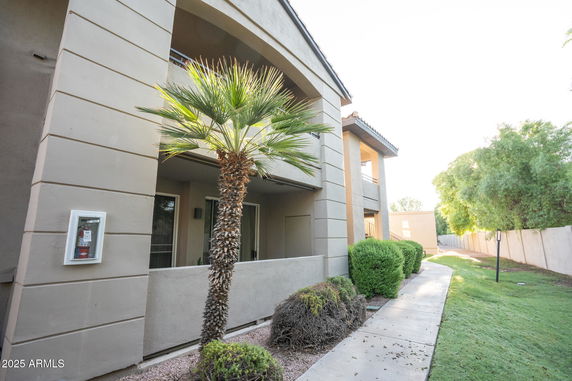 Front view of a modern apartment building with covered balconies.