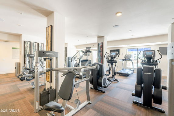Interior view of a fitness center with exercise machines and equipment.