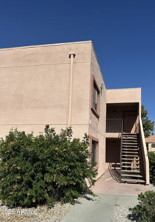 Front view of a two-story building with an exterior staircase.