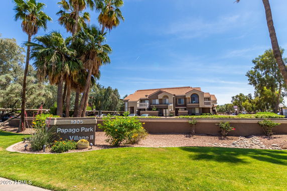 Front view of a two-story residential building with a red-tiled roof and balconies.