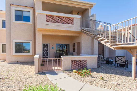 Front view of a two-story residential building with an outdoor staircase.