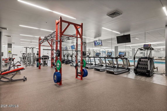 Interior view of a fitness gym with exercise equipment and treadmills.