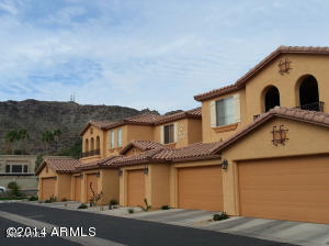 Front view of a multi-story residential building with garages.