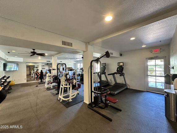 Interior view of a gym with exercise equipment and treadmills.