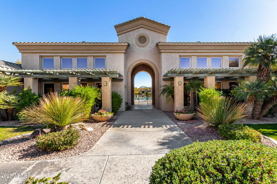 Front view of a house with a central archway entrance.