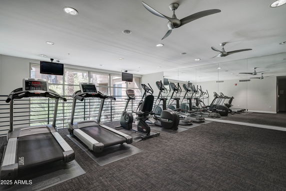 Indoor gym area equipped with treadmills and exercise machines.