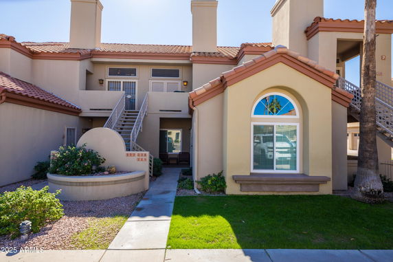 Front view of a multi-story building with stairs leading to the upper level.