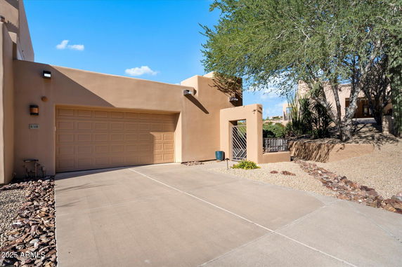Front view of a house with a large garage and a paved driveway.