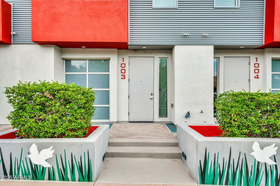 Front view of a modern building with red and white accents.