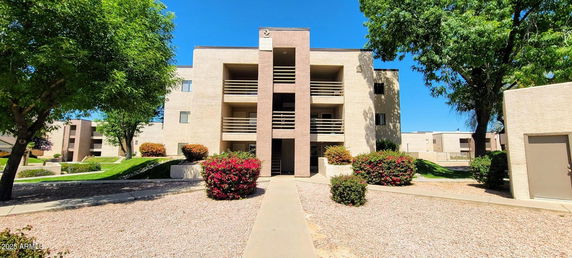 Front view of a three-story residential building with balconies.