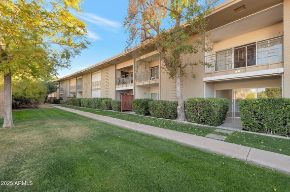 Front view of a two-story apartment building with balconies.
