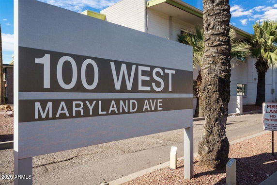 Front view of a building with address plaque reading 100 West Maryland Ave.
