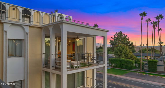 Front view of a multi-story building with balconies.