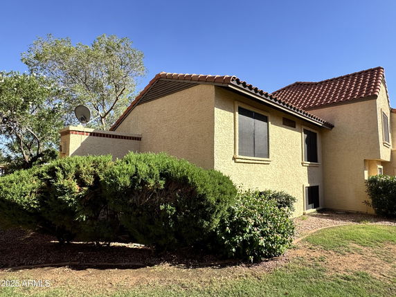 Front view of a single-story house with a red-tiled roof.