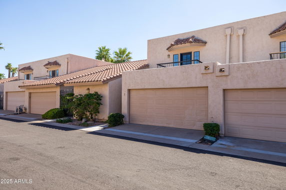Front view of a two-story house with garages.