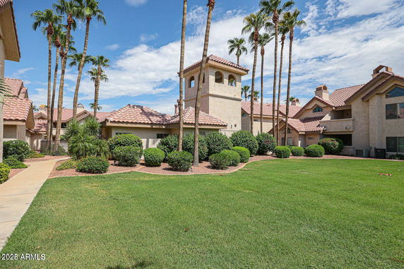 Front view of a residential complex with multiple buildings and red tiled roofs.