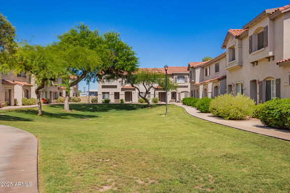 Front view of a residential building complex with red-tiled roofs.