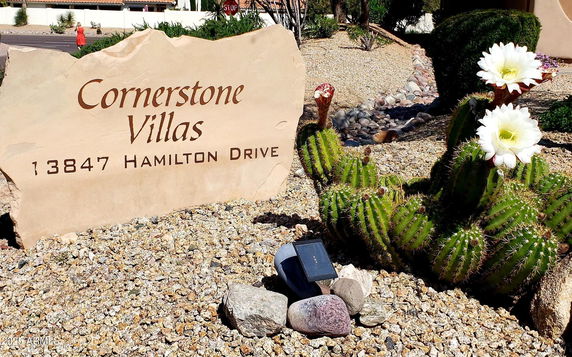 Front view of Cornerstone Villas with a stone sign displaying the address.