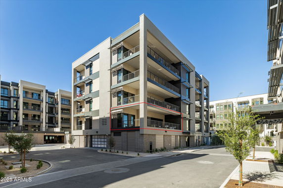 Front view of a multi-story apartment building with balconies.