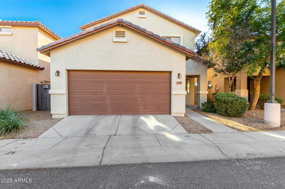 Front view of a house with a brown double garage.