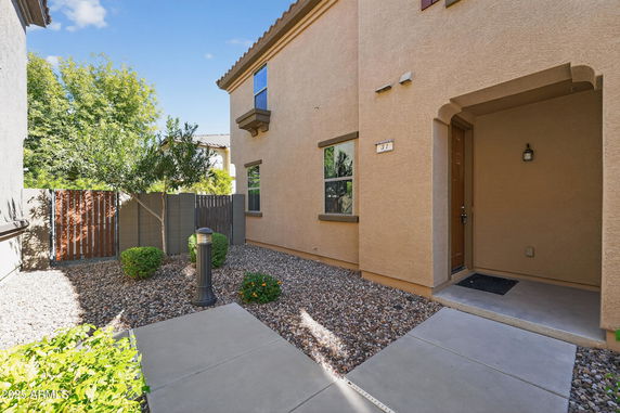 Front view of a two-story house with a brown facade and covered porch entrance.