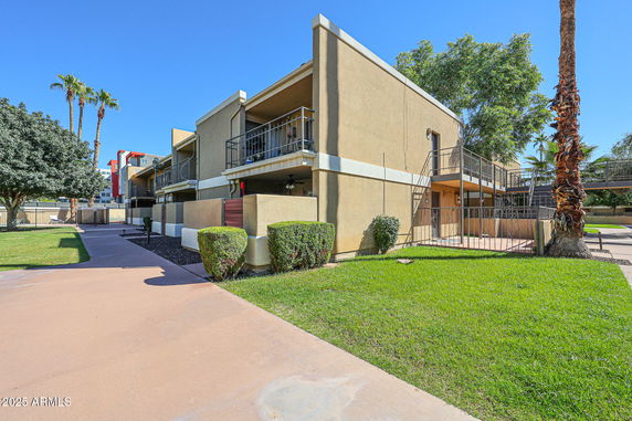 Front view of a two-story apartment building with balconies.