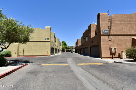 Front view of a series of connected two-story buildings with garages.