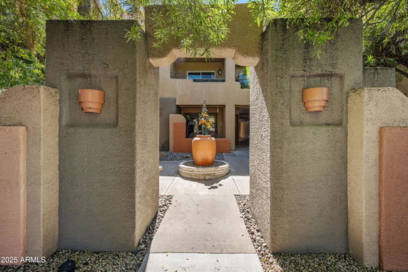 Front view of a house with textured walls and decorative pottery