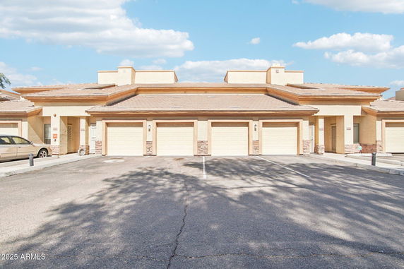 Front view of a multi-garage building with a flat roof.
